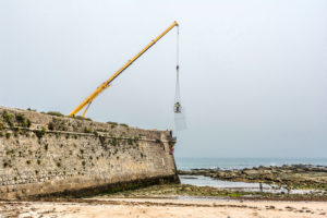 Europe, Portugal, Centro Region, coastal town, Peniche de Cima, Praia da Gamboa, working on the city wall Europe, Portugal, Centro Region, coastal town, Peniche de Cima, Praia da Gamboa, working on the city wall